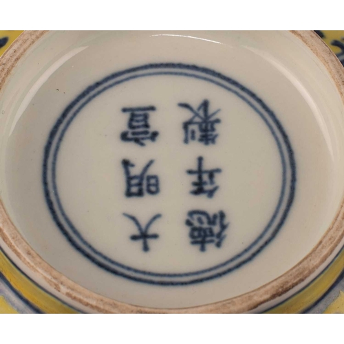 691 - A CHINESE MING STYLE YELLOW-GROUND BLUE AND WHITE 'DRAGON' BOWL painted with twin dragons chasing fl... 