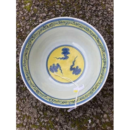 691 - A CHINESE MING STYLE YELLOW-GROUND BLUE AND WHITE 'DRAGON' BOWL painted with twin dragons chasing fl... 