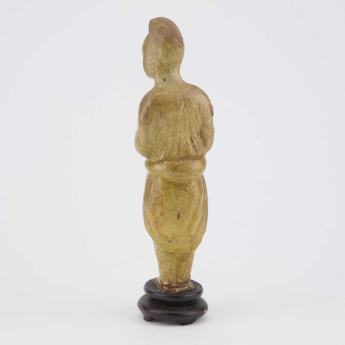 694 - A STRAW-GLAZED FIGURE AND A POTTERY MODEL OF AN OX Sui and Tang Dynasties, the figure standing with ... 