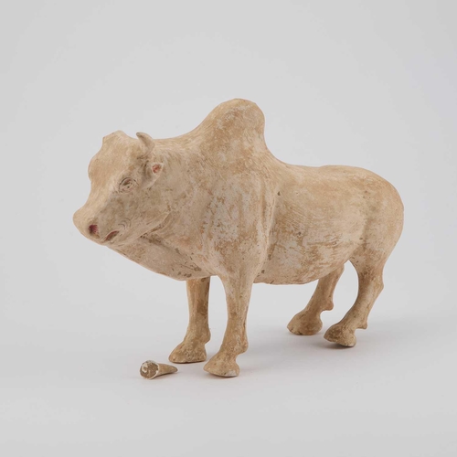 694 - A STRAW-GLAZED FIGURE AND A POTTERY MODEL OF AN OX Sui and Tang Dynasties, the figure standing with ... 