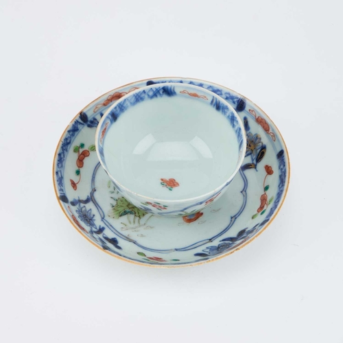 698 - V AN 18TH CENTURY CHINESE FAMILLE ROSE TEA BOWL AND SAUCER the tea bowl decorated with two reserves ... 