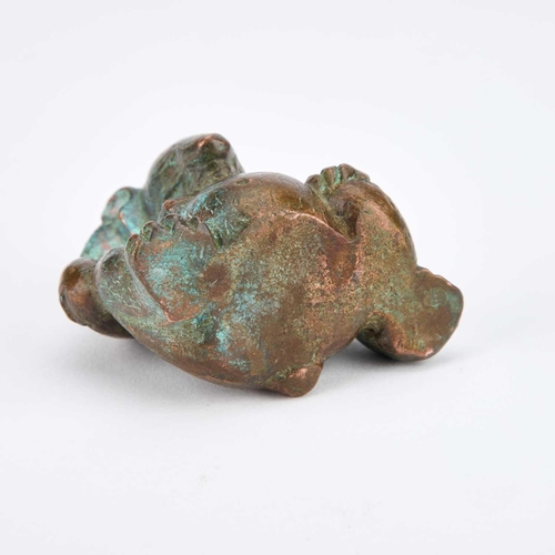 709 - A CHINESE BRONZE HAN-STYLE BEAR modelled sat with one knee raised. 5cm high