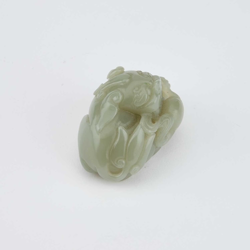 756 - A CHINESE JADE CARVING OF A BUDDHIST LION carved clutching a brocade ball. 5.5cm longIn generally go... 