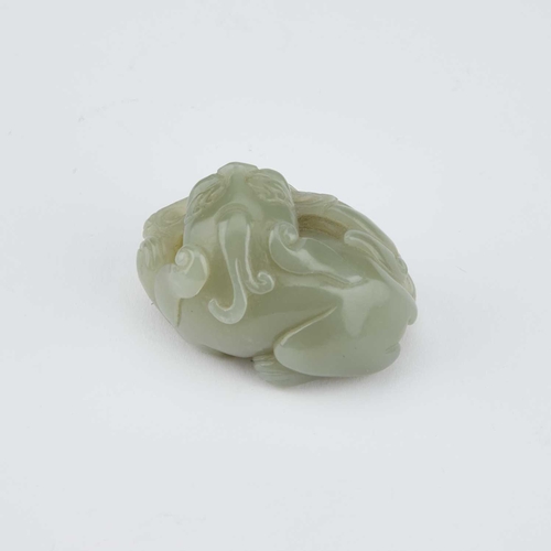 756 - A CHINESE JADE CARVING OF A BUDDHIST LION carved clutching a brocade ball. 5.5cm longIn generally go... 