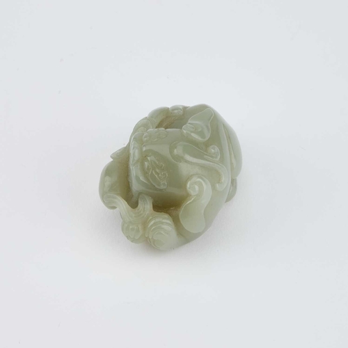 756 - A CHINESE JADE CARVING OF A BUDDHIST LION carved clutching a brocade ball. 5.5cm longIn generally go... 