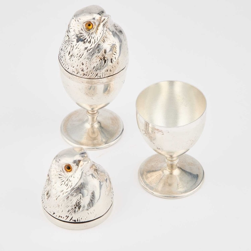 232 - A PAIR OF SILVER-PLATED NOVELTY EGG CUPS each egg cup of usual form with a removable chick-shaped co... 