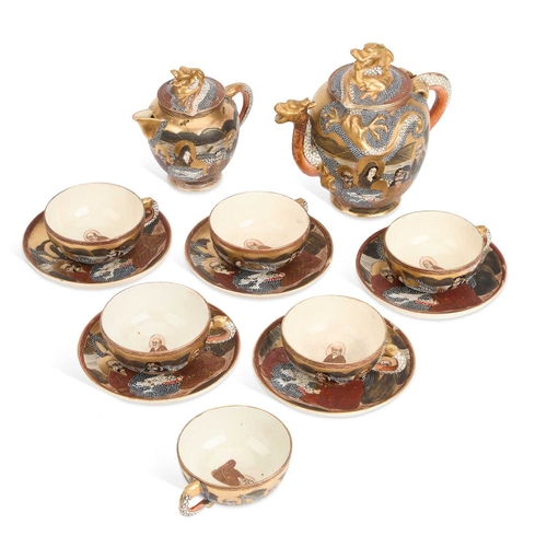 242 - AN EARLY 20TH CENTURY JAPANESE SATSUMA PARTIAL TEA SERVICE comprising a teapot, cream jug, six cups ... 