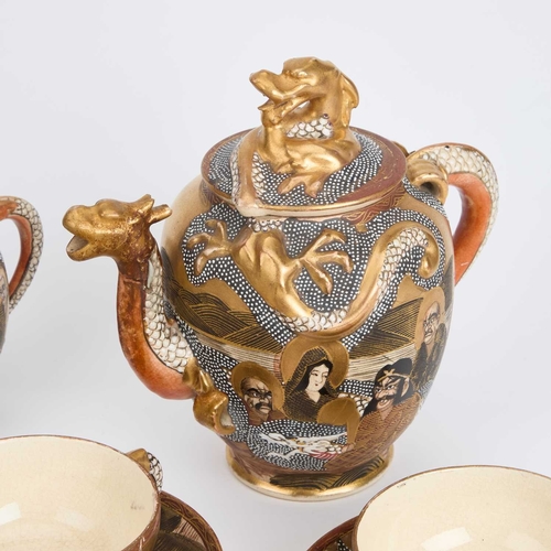 242 - AN EARLY 20TH CENTURY JAPANESE SATSUMA PARTIAL TEA SERVICE comprising a teapot, cream jug, six cups ... 