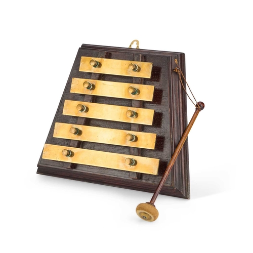 39 - AN EARLY 20TH CENTURY WALL XYLOPHONE the five brass keys mounted on an trapezium-shaped oak base, wi... 
