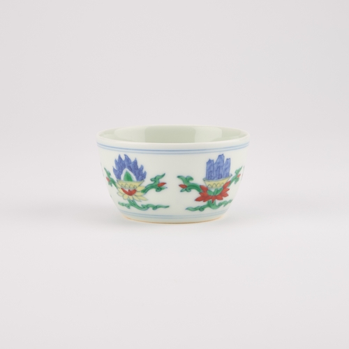 103 - A CHINESE DOUCAI CUP decorated with flowers, bears an underglaze blue six-character mark in a double... 