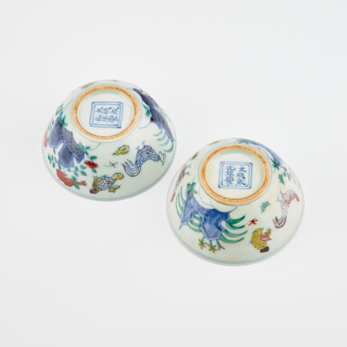 109 - A PAIR OF CHINESE DOUCAI 'CHICKEN' CUPS each bears an underglaze blue six-character mark in a double... 