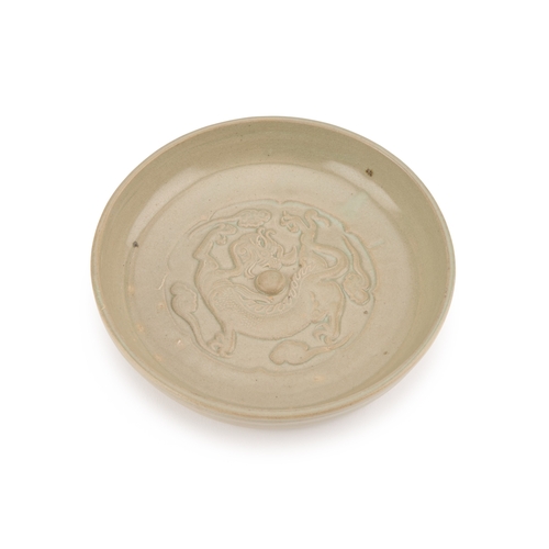 119 - A CHINESE CELADON BRUSH WASHER circular, moulded in relief with a Kylin. 17.5cm diameter