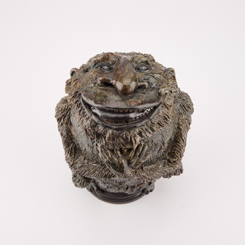 37 - CLIVE SOORD: A STONEWARE GROTESQUE JAR AND COVER IN THE MANNER OF THE MARTIN BROTHERS modelled as a ... 