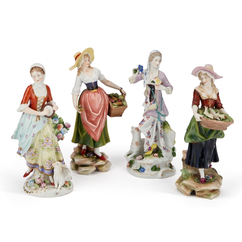 40 - TWO PAIRS OF CONTINENTAL PORCELAIN FIGURES, CIRCA 1900 each modelled as a lady in 18th Century dress... 