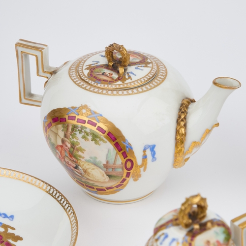 52 - A GERMAN PORCELAIN TEA AND CHOCOLATE SERVICE comprising a teapot, chocolate pot, cream jug, sucrier ... 