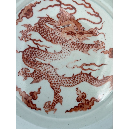 67 - A CHINESE CELADON-BACK IRON-RED 'DRAGON' DISH decorated with a five-claw dragon and cloud scrolls, b... 