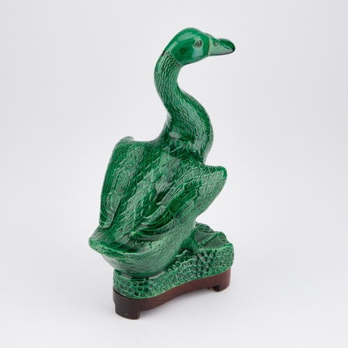 68 - A CHINESE GREEN-GLAZED MODEL OF A DUCK on a wooden stand. (2) 24.5cm high overall