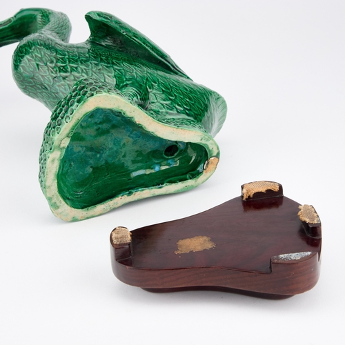 68 - A CHINESE GREEN-GLAZED MODEL OF A DUCK on a wooden stand. (2) 24.5cm high overall