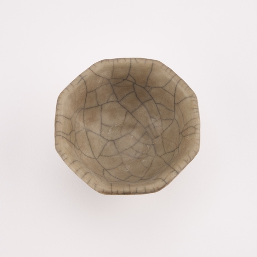 72 - A CHINESE CRACKLE-GLAZE CUP octagonal. 9cm diameter