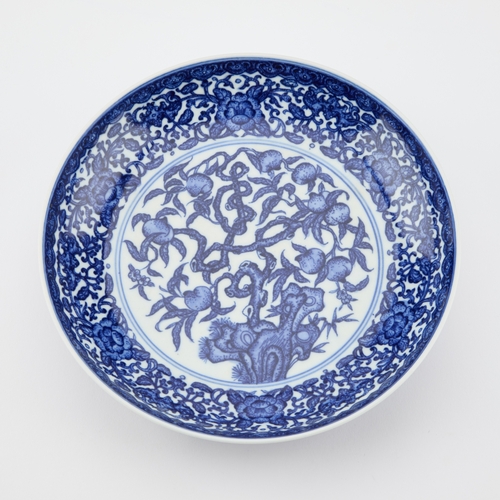 75 - A CHINESE BLUE AND WHITE SAUCER DISH bears a six-character mark in double rings. 21cm diameter... 
