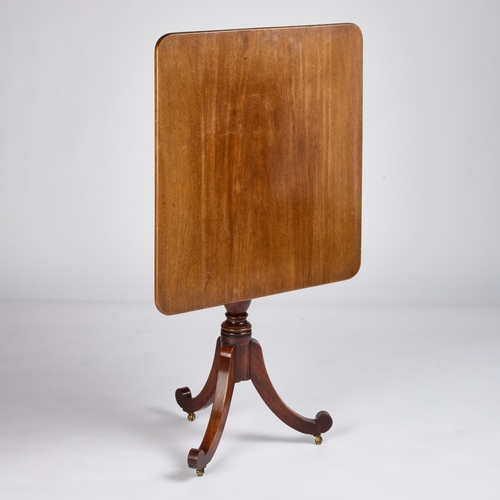 766 - A EARLY 19TH CENTURY MAHOGANY TILT-TOP TRIPOD TABLE the off-square top raised on a ring-turned balus... 