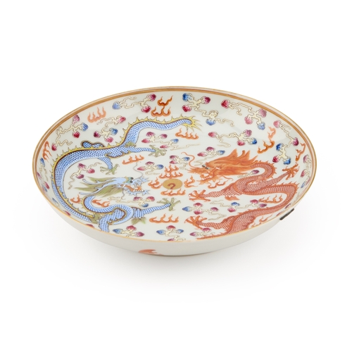 77 - A CHINESE IRON-RED AND ENAMEL 'DRAGON' DISH painted with two dragons and a flaming pearl, bears an u... 