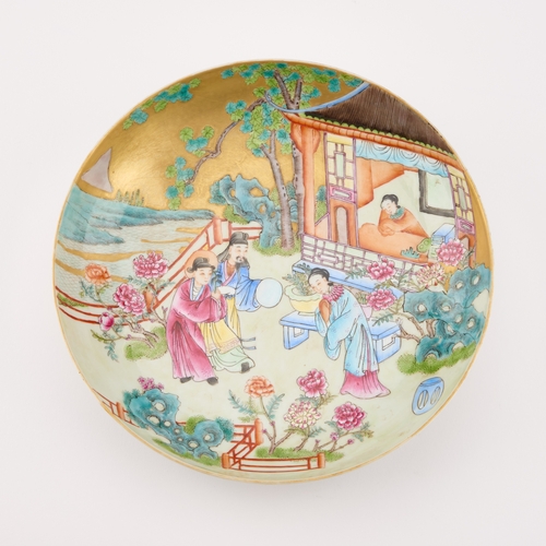 80 - A CHINESE FAMILLE ROSE DISH painted with figures in an extensive landscape, bears an underglaze blue... 