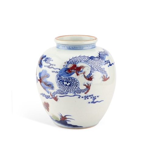 89 - A CHINESE UNDERGLAZE BLUE AND COPPER-RED 'DRAGON' GINGER JAR moulded in relief with trees and rocks,... 