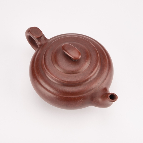 91 - A CHINESE YIXING TEAPOT bears an impressed mark. 20cm long