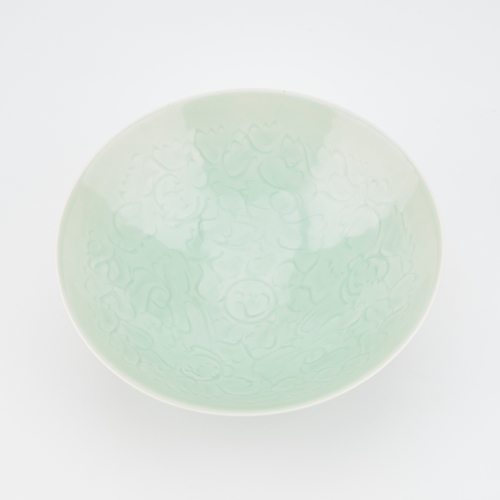 94 - A CHINESE CELADON-GROUND BOWL with incised and moulded decoration. 21cm diameter