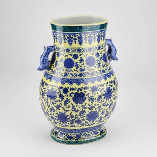 104 - A LARGE MING STYLE VASE, HU decorated in underglaze blue and yellow with scrolling foliage, bears un... 