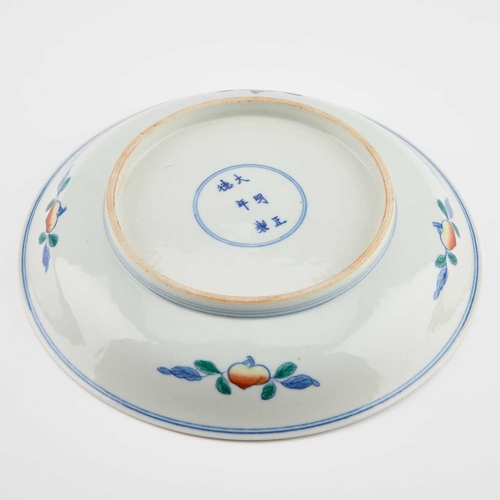 120 - A CHINESE DOUCAI BIRTHDAY DISH the centre with a finely enamelled peach enclosing a crane in flight,... 