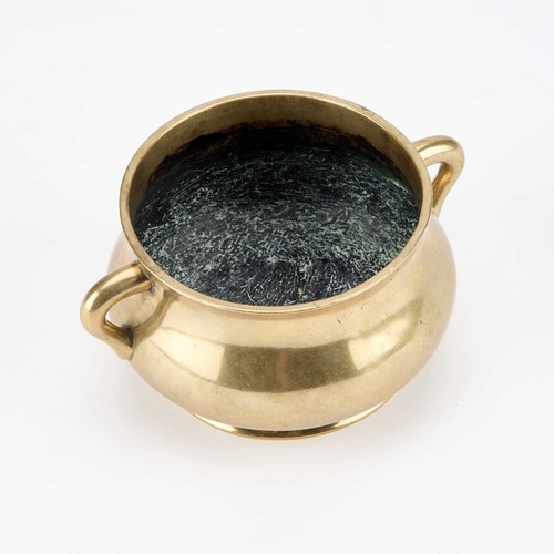 149 - A CHINESE BRONZE CENSER the rounded sides with lug handles, bears cast seal mark. 14.5cm across hand... 