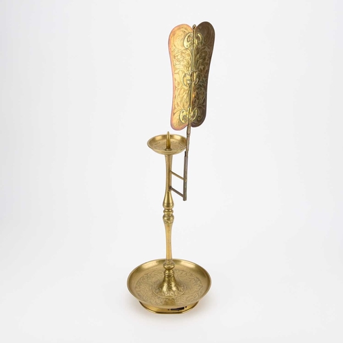 168 - A BRASS AND TIN CANDLESTAND AND REFLECTOR, PROBABLY KOREAN, CIRCA 1900-1905 the tin reflector decora... 