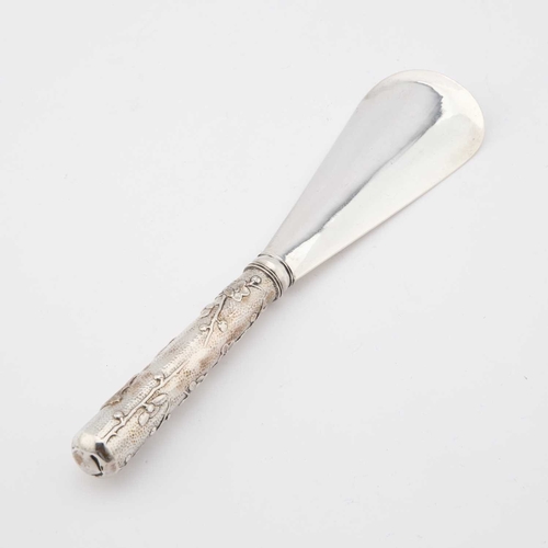 215 - A CHINESE SILVER SHOE-HORN unmarked, the handle decorated with a bird and prunus blossom. 22cm long,... 