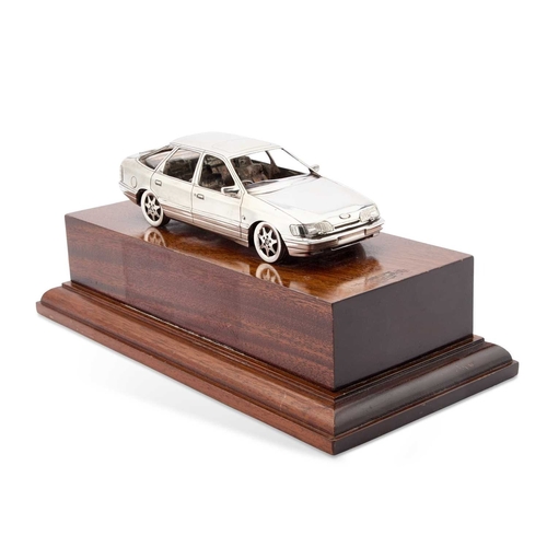 310 - AN ELIZABETH II SILVER MODEL OF A FORD SCORPIO CAR by Garrard & Co Ltd, London 1989, on a wooden... 