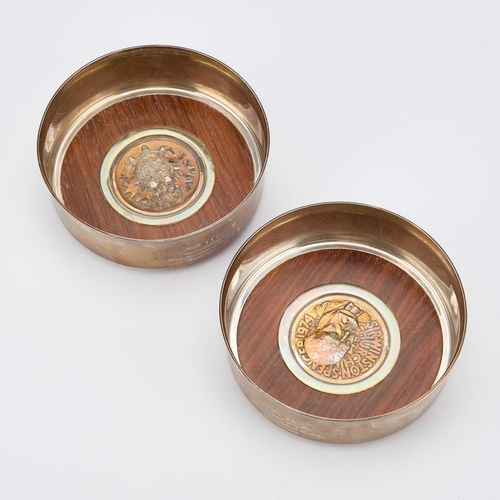 318 - CHURCHILL MEMORABILIA: A PAIR OF PARCEL-GILT SILVER CHURCHILL CENTENARY COASTERS by Garrard & Co... 