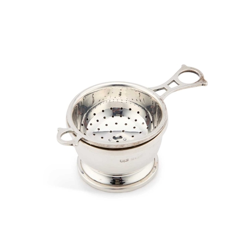 321 - A GEORGE VI SILVER TEA STRAINER AND BOWL by Mappin & Webb Ltd, Birmingham 1944. (2) 10.3cm long,... 