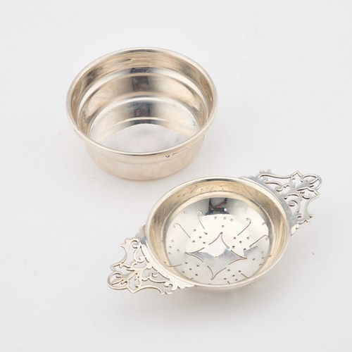 362 - AN ELIZABETH II SILVER TEA STRAINER AND BOWL by S J Rose & Son, Birmingham 1971, on an underbowl... 