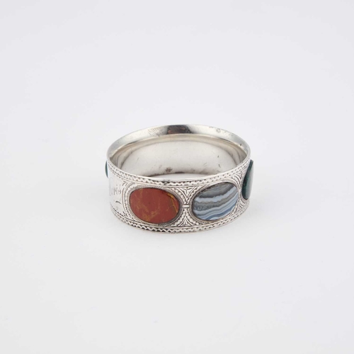 366 - AN EDWARDIAN SILVER AND HARDSTONE NAPKIN RING by James Fenton, Birmingham 1902, circular, inscribed ... 