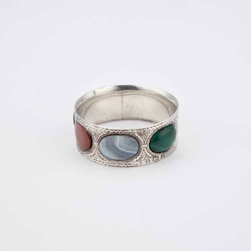 366 - AN EDWARDIAN SILVER AND HARDSTONE NAPKIN RING by James Fenton, Birmingham 1902, circular, inscribed ... 