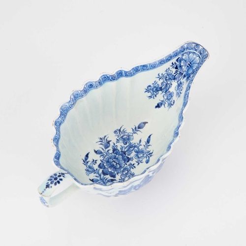 45 - A BOW FLUTED SAUCEBOAT, CIRCA 1760 silver-shaped, painted in blue with a 'Desirable Residence' type ... 