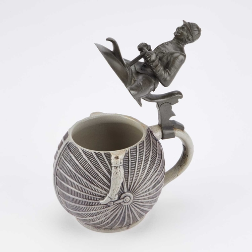 50 - A RARE PEWTER-MOUNTED SALT-GLAZED STONEWARE NOVELTY BEER STEIN modelled as a cyclist. 18cm high... 