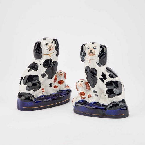 63 - A NEAR PAIR OF VICTORIAN STAFFORDSHIRE POTTERY MODELS OF GREYHOUNDS together with a pair of pottery ... 