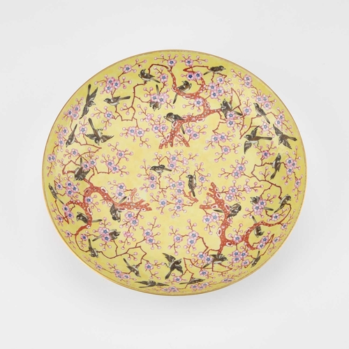 69 - A CHINESE YELLOW-GROUND DISH enamel decorated with birds amidst prunus blossom. 21cm diameter