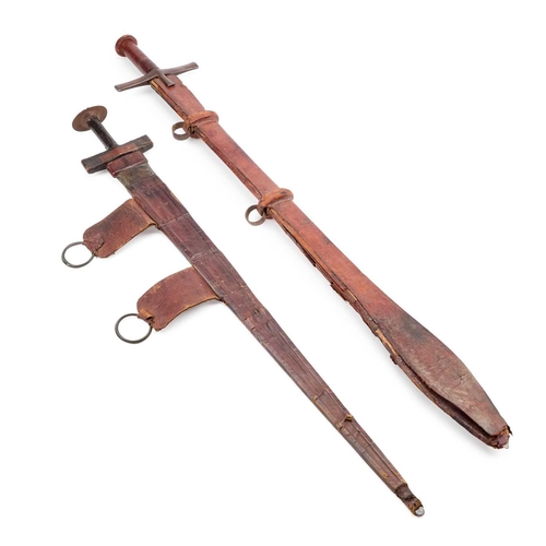 7 - TWO TAKOUBA WITH SCABBARDS each with a tapering blade, one with a pair of crescent moons to either s... 