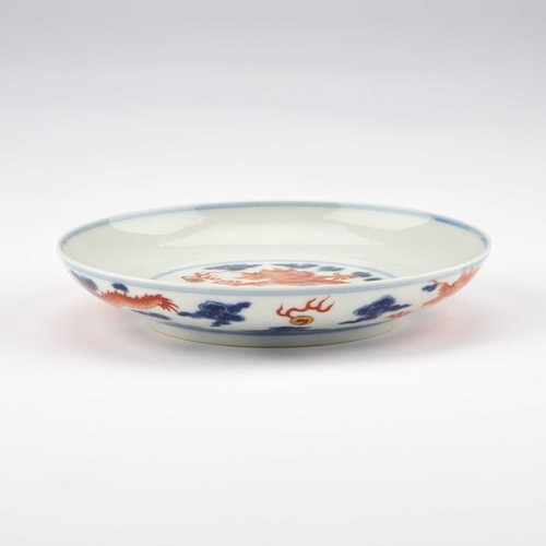 74 - A CHINESE UNDERGLAZE BLUE AND IRON-RED 'DRAGON' DISH 16cm diameter