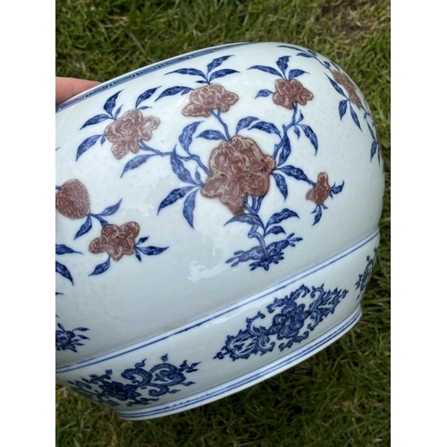 76 - A LARGE CHINESE UNDERGLAZE-BLUE AND COPPER-RED CENSER circular, painted with a Key pattern border ar... 