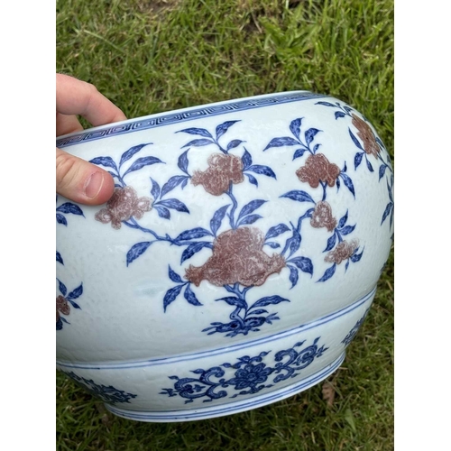 76 - A LARGE CHINESE UNDERGLAZE-BLUE AND COPPER-RED CENSER circular, painted with a Key pattern border ar... 