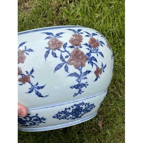 76 - A LARGE CHINESE UNDERGLAZE-BLUE AND COPPER-RED CENSER circular, painted with a Key pattern border ar... 